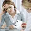 A woman sitting at a table with another person.