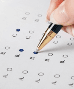 A person is filling out an exam paper with a pen.