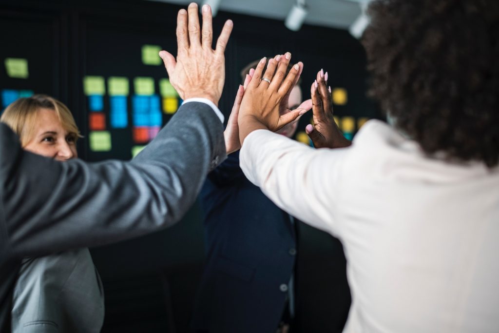 A group of people with their hands up.