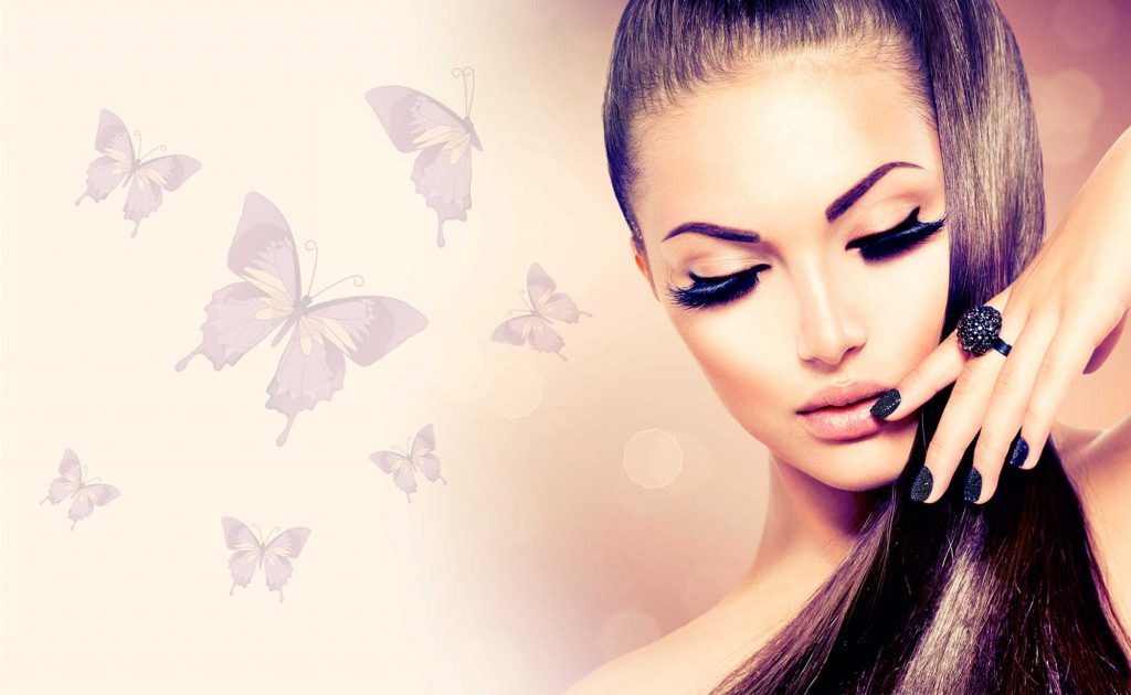 A woman with long hair and butterfly makeup.