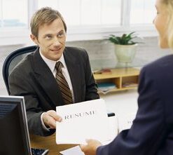 A man in suit and tie holding an envelope.