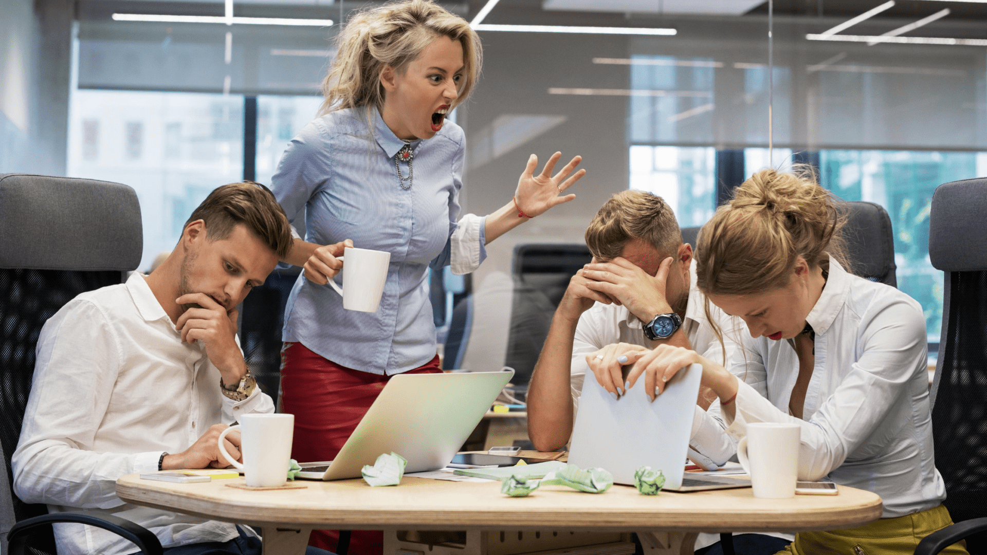 A woman is yelling at people on the table