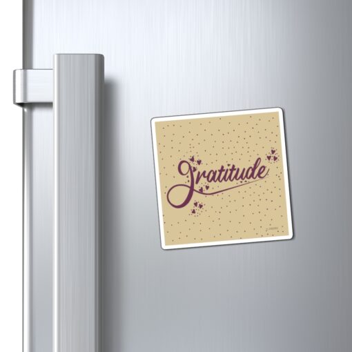 A refrigerator magnet with the word gratitude on it.