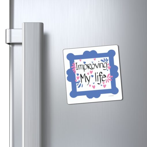 A refrigerator magnet with the words " improvely my life ".