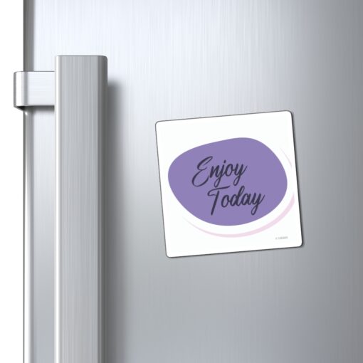 A refrigerator magnet that says " enjoy today ".