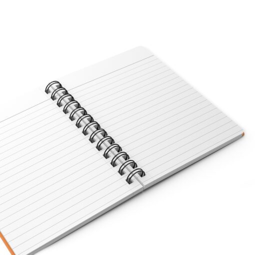 A spiral notebook with lined paper on top of it.