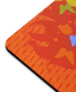 A close up of the bottom corner of an orange mouse pad.