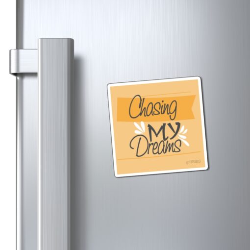 A refrigerator magnet with the words " chasing my dreams ".